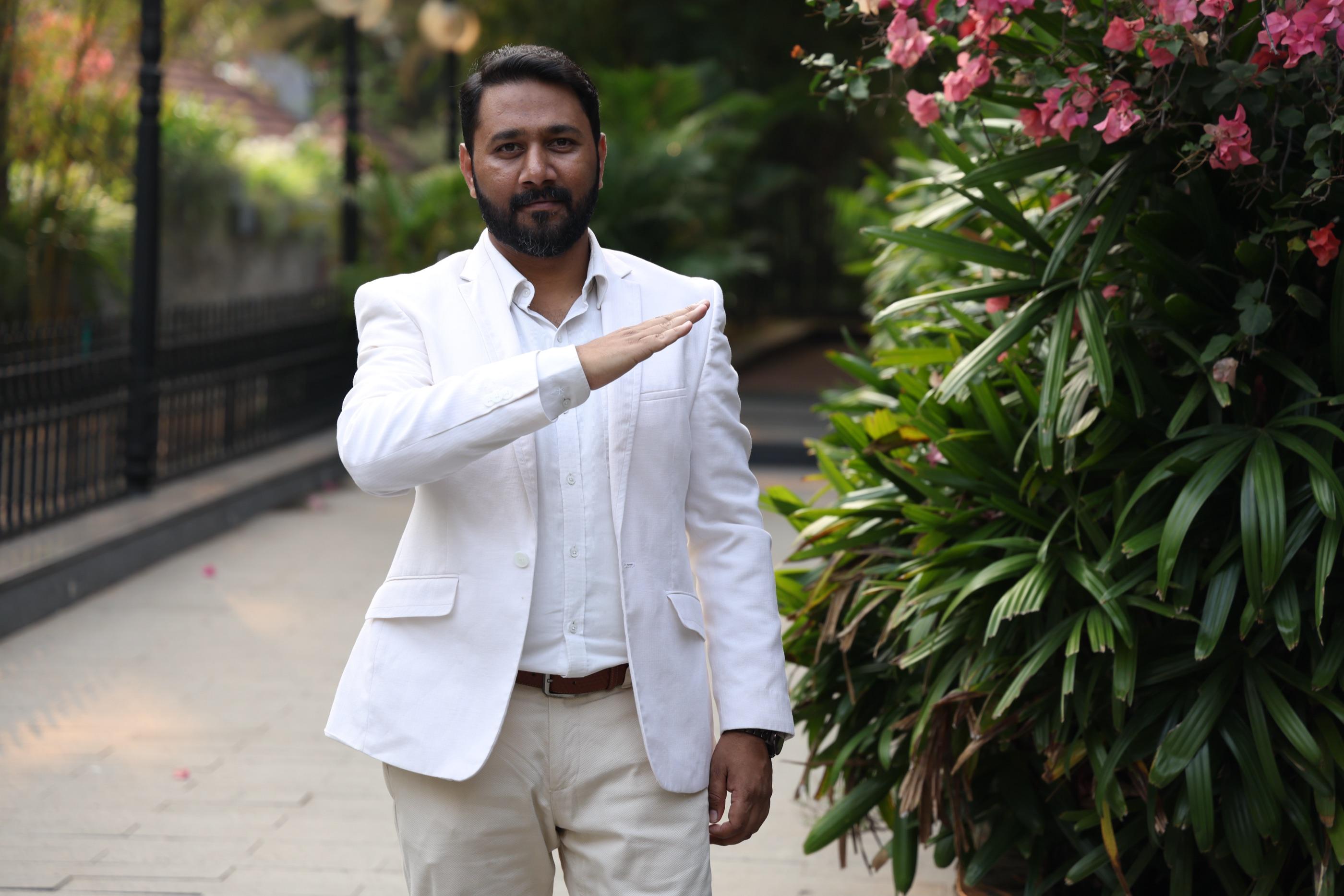 James Vineeth (JV) in a white blazer